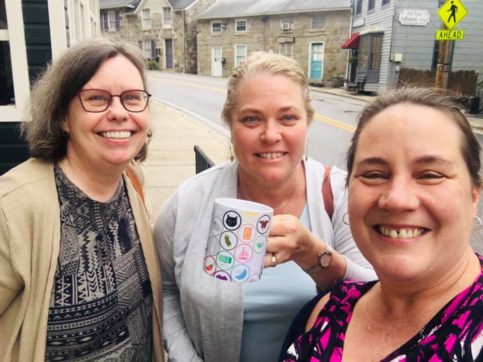 Three teachers with a Color Vowel® mug